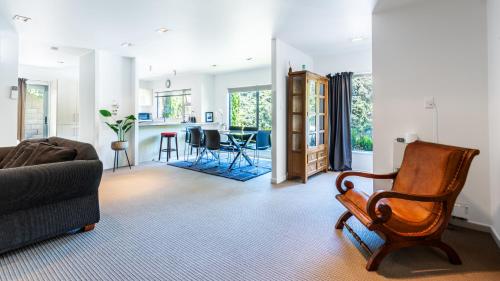 a living room with a couch and a chair at Villa Sebastian - Large Modern Home in Wellington