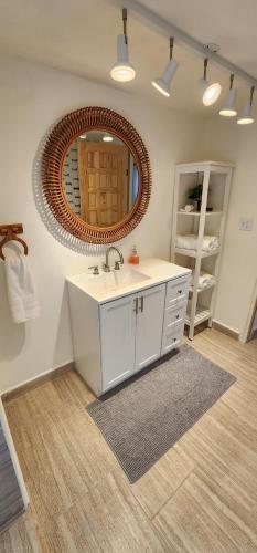 a bathroom with a sink and a mirror at Casa Canes - Beachfront Doggy Living! in Ensenada