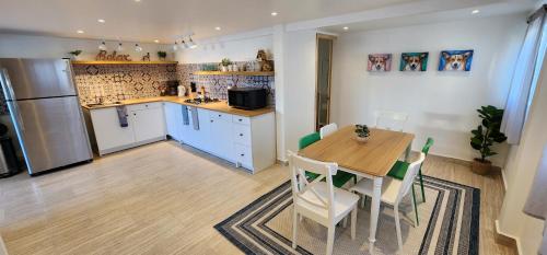 a kitchen and dining room with a table and a refrigerator at Casa Canes - Beachfront Doggy Living! in Ensenada