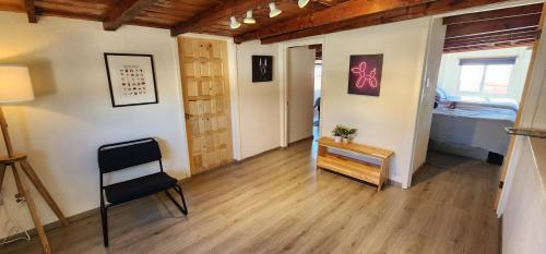 a room with a table and a chair and a bedroom at Casa Canes - Beachfront Doggy Living! in Ensenada