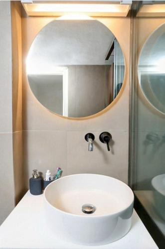 a white sink in a bathroom with a mirror at Agistri House Pefkohori in Pefkochori