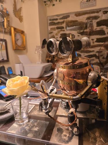 a robot sitting on a table with a pot at Antouanetta Apartments in Ermoupoli