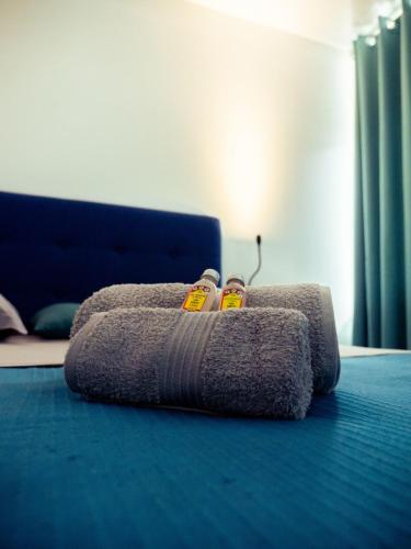a pile of towels on a bed in a room at A340 citi center room in Papeete