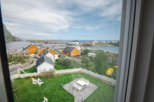 a view from a window of a yard with a playground at Sakrisøy Gjestegård - Manor House in Sakrisøy - Solbakken anno 1880 in Reine