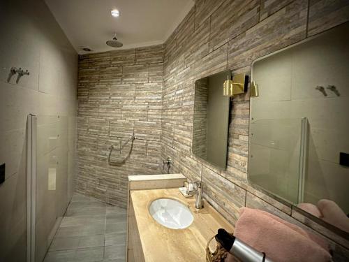 a bathroom with a sink and a mirror at La Blanca Hotel in Viña del Mar