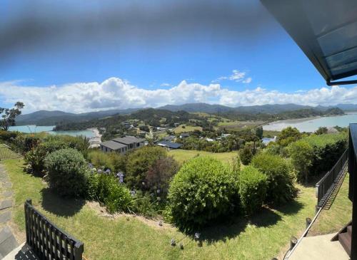 a view from the balcony of a house with a lake at Coromandel Seaview Motel in Coromandel Town