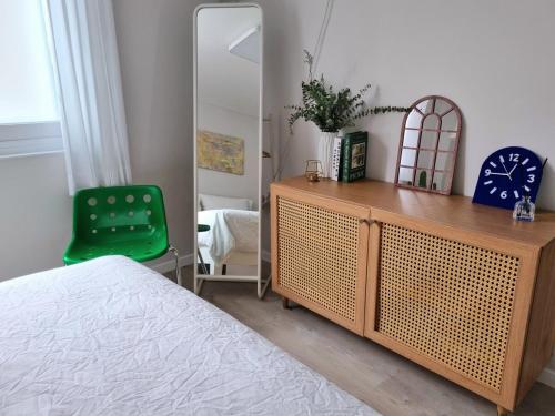 a bedroom with a wooden dresser and a mirror at Wanna Stay in Suwon