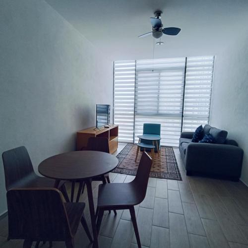 a living room with a table and chairs and a couch at RIBERA DE CHAPALA Suites in Chantepec