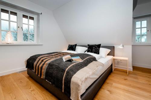 a bedroom with a large bed and two windows at LITZKOW 12808 in Westerwall