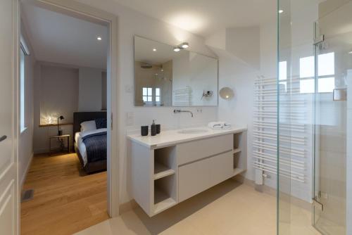 a bathroom with a sink and a glass shower at LITZKOW 12808 in Westerwall