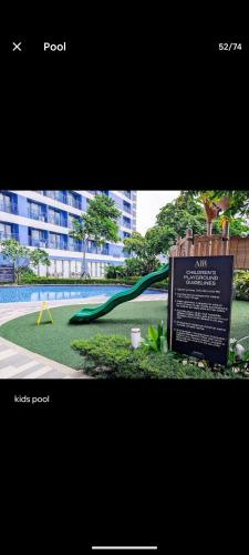 a picture of a park with a green slide at 1 bedroom Cozy Escape in Manila