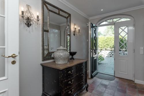 a hallway with a mirror and a vase on a dresser at LITZKOW 15808 in Morsum