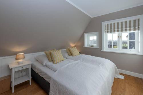 a bedroom with a white bed and a window at LITZKOW 12806 in Westerwall