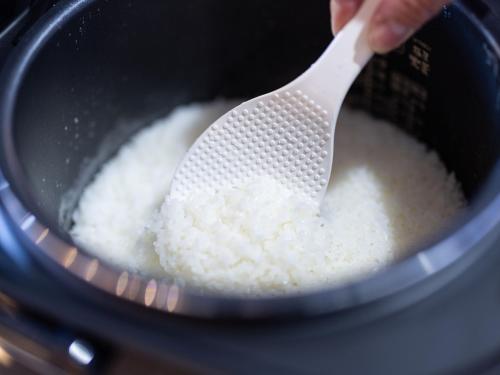a person holding a plastic spoon in a pot of rice at APA Hotel Akabane Iwabuchi Ekimae in Tokyo