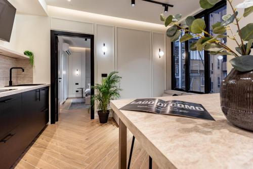 a kitchen with a table with a book on it at Lungolago Modern FD Apartments in Como