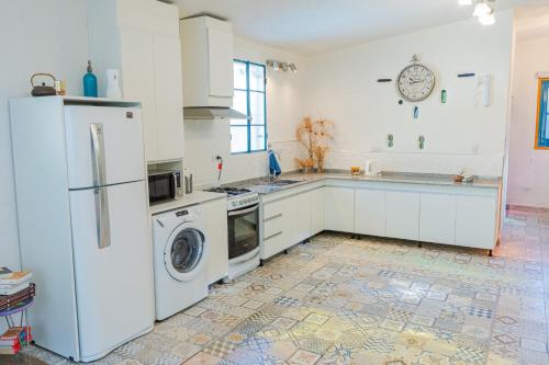 a kitchen with white appliances and a tile floor at Ocampo Catamarca in San Fernando del Valle de Catamarca
