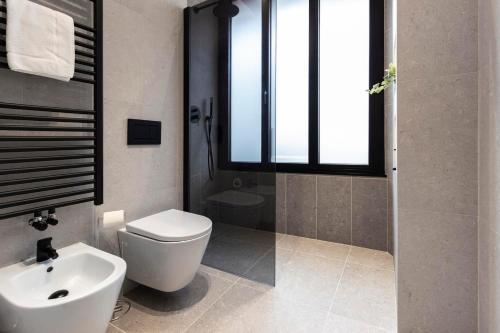 a bathroom with a toilet and a sink at Lungolago Modern FD Apartments in Como