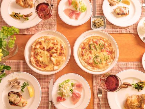 a table with plates of food on a table at Pension Himawari in Iizuna
