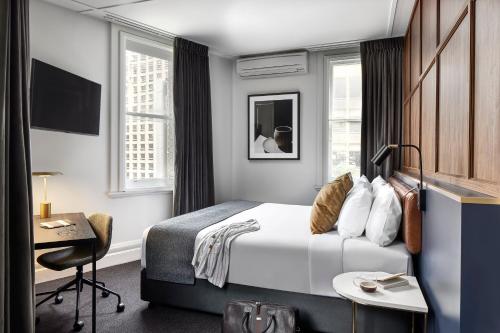 a hotel room with a bed and a desk at Veriu Central in Sydney