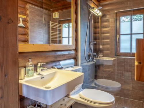 a bathroom with a white sink and a toilet at Yosi im Brixental in Wörgler Boden