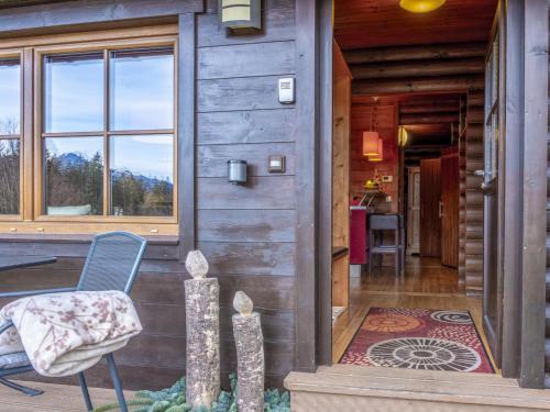 a door to a cabin with a chair and a rug at Yosi im Brixental in Wörgler Boden