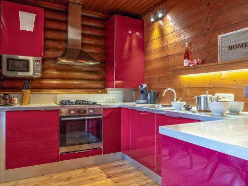 a kitchen with red cabinets and a stove at Yosi im Brixental in Wörgler Boden