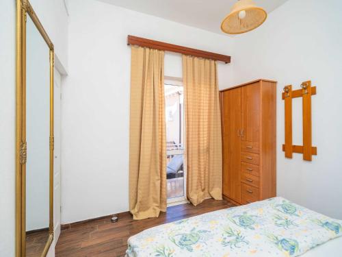 a bedroom with a bed and a dresser and a window at Apartments Senjo - One Bedroom Apartment with Balcony and Sea View 4 adults Apartman 3 in Cavtat