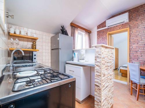 a kitchen with a stove and a refrigerator at Apartments Senjo - One Bedroom Apartment with Balcony with Sea View Apartman 1 in Cavtat