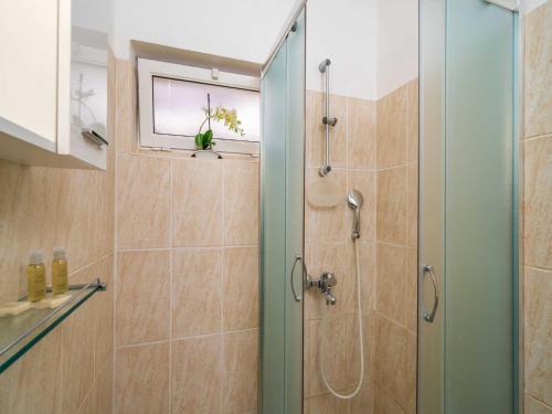 a bathroom with a shower with a glass door at Apartments Senjo - Studio Apartment with Balcony with Side Sea View Apartman 4 in Cavtat