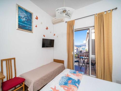 a bedroom with a bed and a balcony at Apartments Senjo - Studio Apartment with Balcony with Side Sea View Apartman 4 in Cavtat
