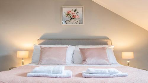 a bedroom with a bed with two towels on it at Queen Anne's Home in Great Yarmouth