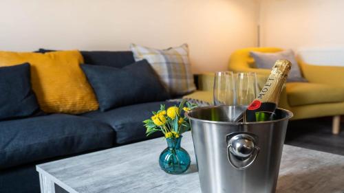 a metal bucket with wine bottles and glasses on a table at Queen Anne's Home in Great Yarmouth