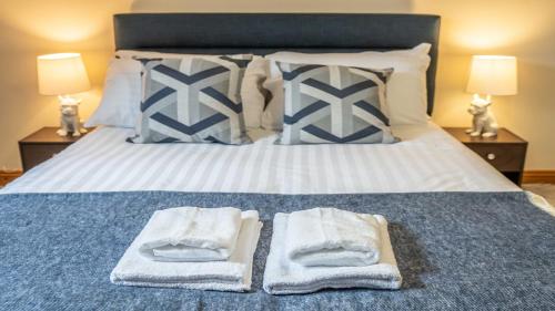 a bedroom with a bed with towels on it at Queen Anne's Home in Great Yarmouth