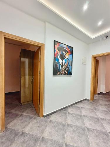 an empty room with a painting on the wall at Playa Surf House in Tamraght Ouzdar