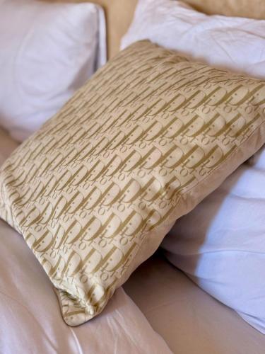 a pillow sitting on top of a bed at Playa Surf House in Tamraght Ouzdar