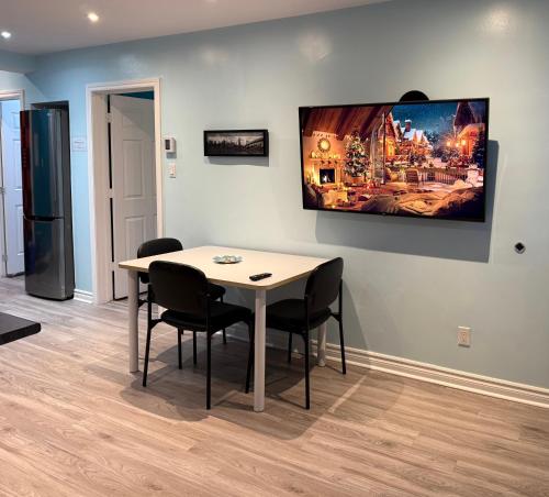 a dining room with a table and two chairs at A&I Cosy&Bright Apartments near Old Port and South Shore in Longueuil