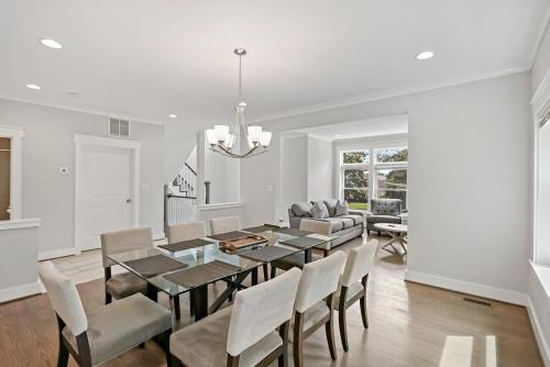 a dining room with a table and chairs at The Ultimate Luxury Home with Jacuzzi & Garage in Falls Church