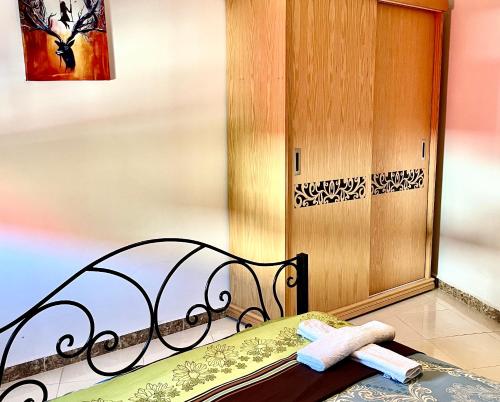 a bed with two towels on it next to a door at Moderno apartamento en el centro , a 3 min del mar lll in Asilah