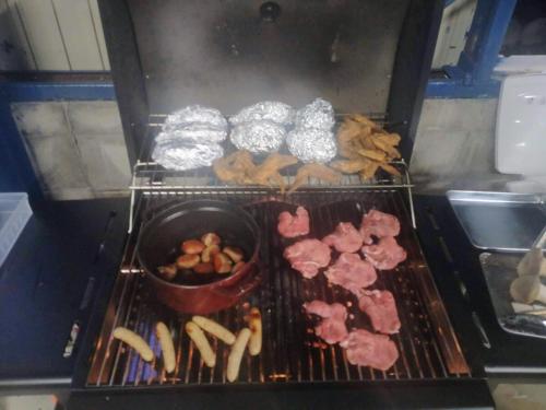 a grill with meat and other food on it at 岐阜羽島の隠れ家 古民家cocone in Hashima