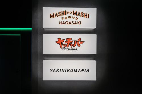 a set of three signs for the masjid khashoggi masaturdays at Stadium City Hotel Nagasaki in Nagasaki