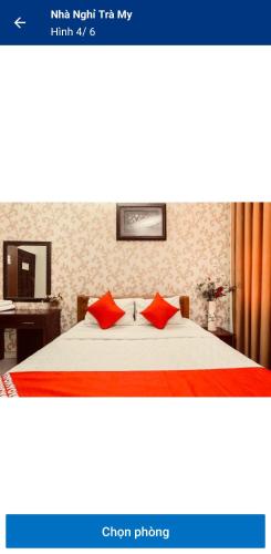 a bedroom with a bed with red pillows on it at NHÀ NGHỈ TRÀ MY NAM ĐỊNh in Vu Bản