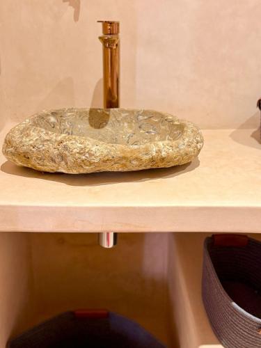 a rock sitting on top of a shelf at Playa Surf House in Tamraght Ouzdar