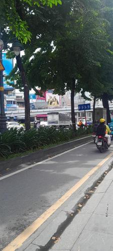 a motorcycle parked on the side of a street with trees at NHÀ NGHỈ TRÀ MY NAM ĐỊNh in Vu Bản