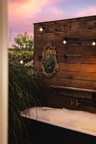 a mirror on the side of a wooden wall at Kookaburra Cottage - 10 minutes from Mount Gambier CBD in Yahl Paddock