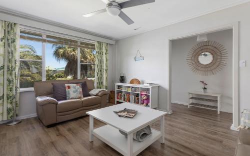 a living room with a couch and a table at Seaside Escape - 4 Brittain St, Port Elliot in Port Elliot