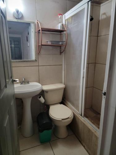 a small bathroom with a toilet and a sink at Aguilas Room 1 in Guadalajara