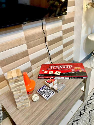 a table with a book and toys on it at Adi Hideaway Staycation at Camella Northpoint 2 Bedroom in Davao City