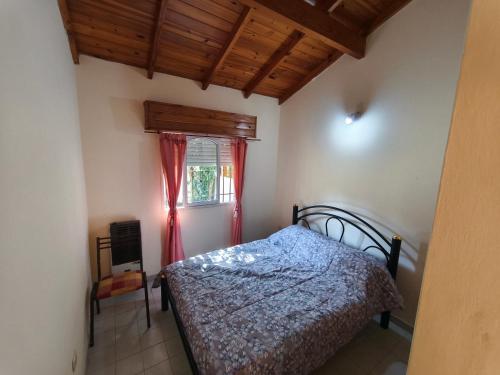 a bedroom with a bed and a window at Chalet Mar de Ajo in Mar de Ajó