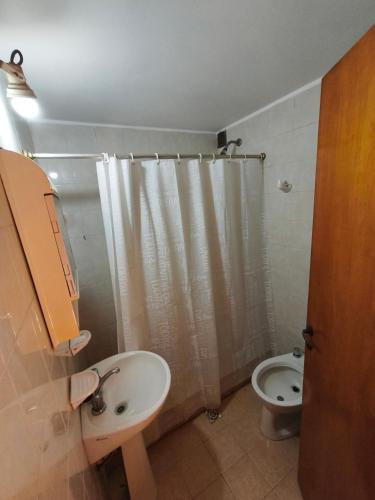 a bathroom with a sink and a toilet at Chalet Mar de Ajo in Mar de Ajó