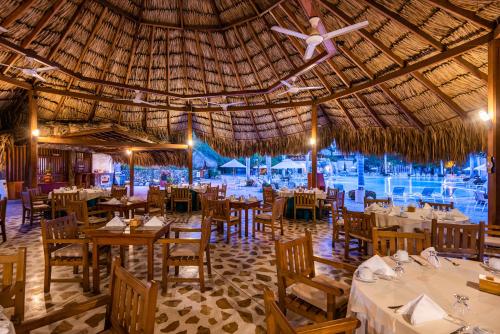 a restaurant with tables and chairs and a ceiling at Hotel Irotama XXI in Santa Marta